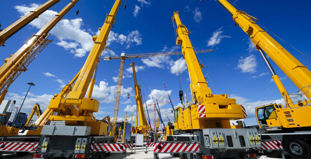 Mobile construction cranes with yellow telescopic arms and big t