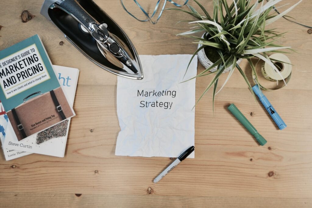 Various marketing materials spread across a wooden tabletop